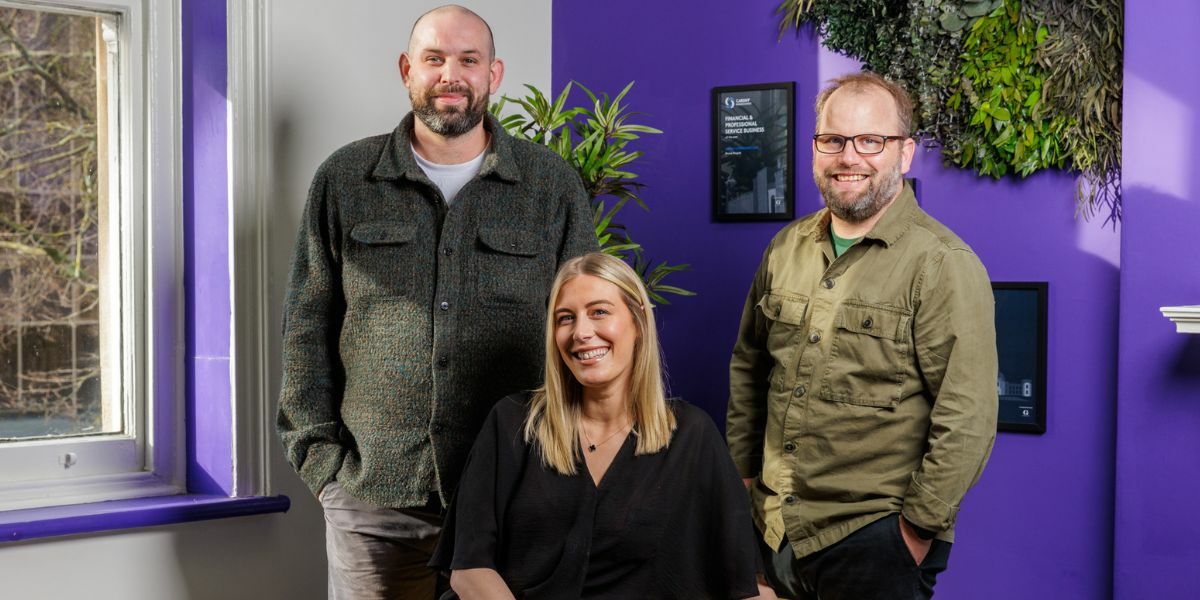 Sam, Lucy and Brett Standing in The Moxie Office