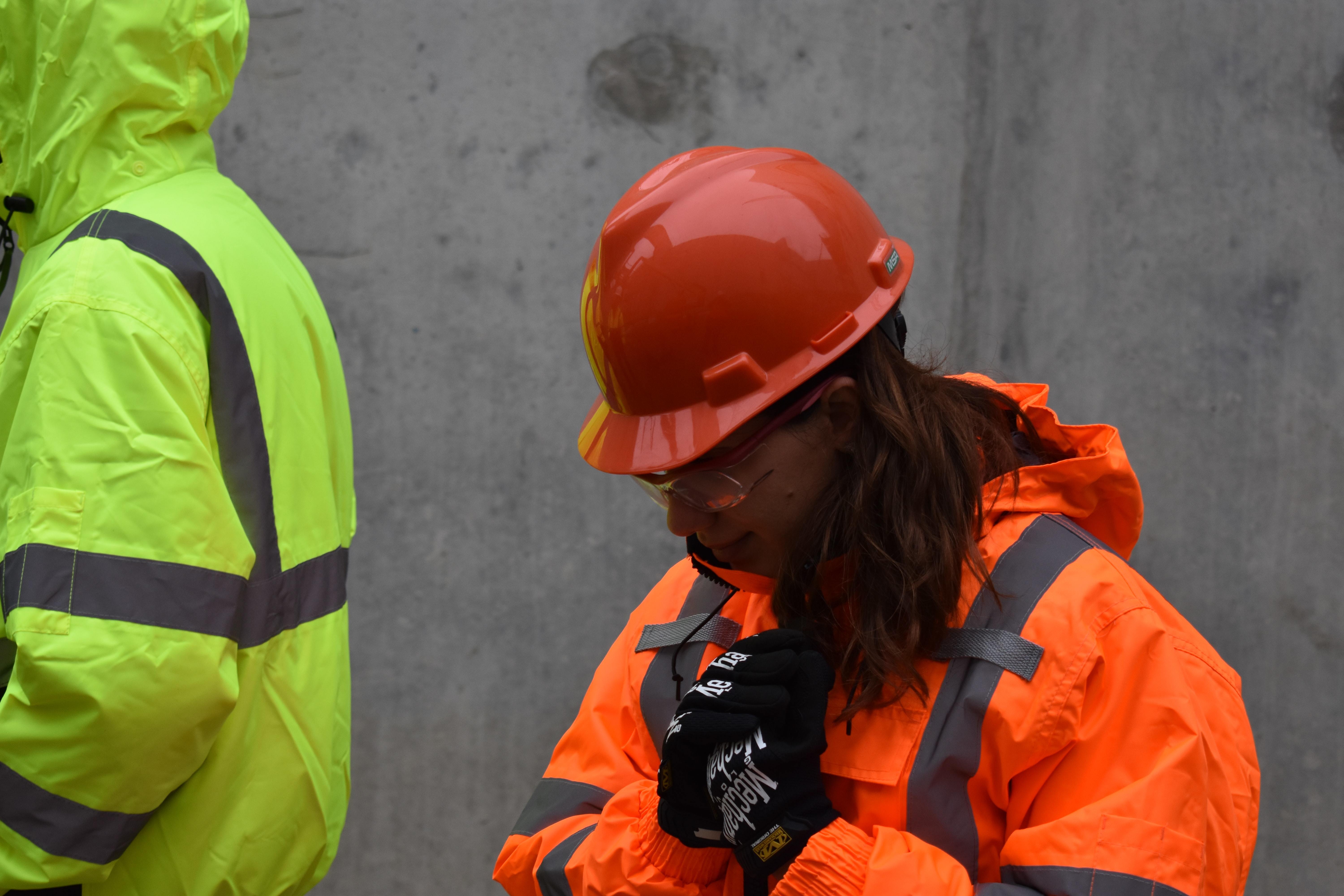Woman construction worker in housing wearing a helmet